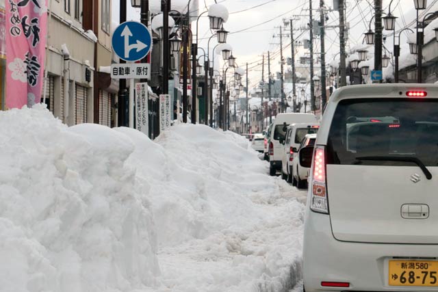 燕地区の商店街は駐車スペースが雪に埋もれた