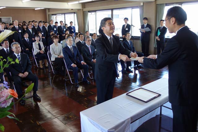 国定市長から退職舎に辞令書を手渡す