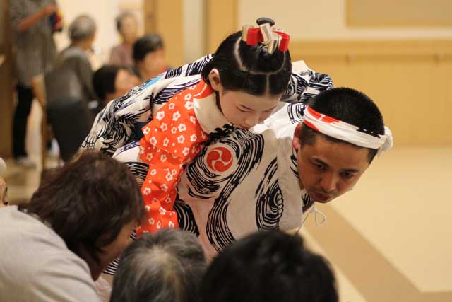 特別養護老人ホーム「燕愛宕の園」で初めての門付けで踊ったあとに入所者一人ひとりと握手するお玉