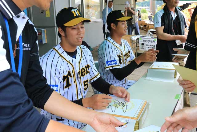 サインする阪神の青柳晃洋投手(左)と石井将希投手