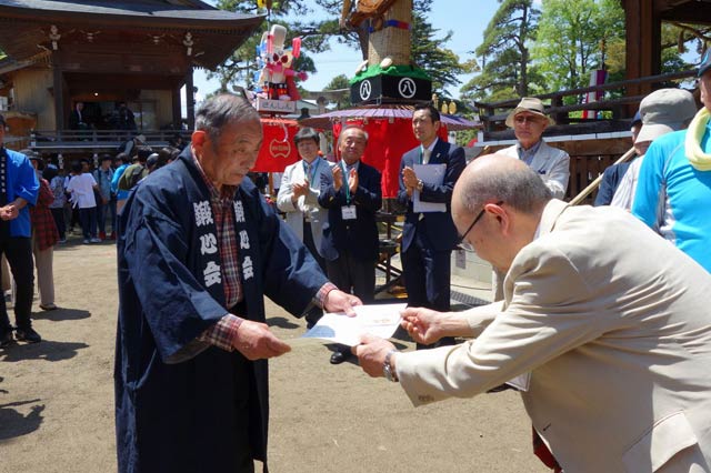 井村会長(右)から金賞の鍛冶町へ表彰状を手渡す
