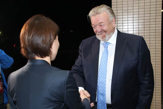 市役所玄関に出てバシーリ・チトフ会長を迎える藤田市長