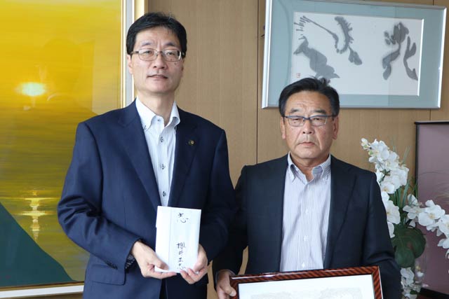 燕市に100万円を寄付した桜井さん(右)と鈴木市長