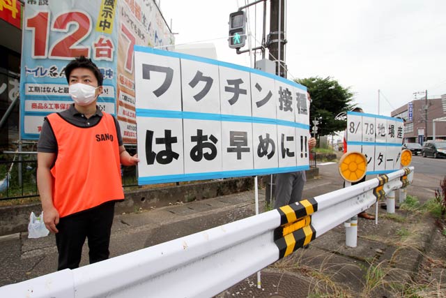 滝沢市長(左)自らつじ立ちし若い世代のワクチン接種を呼びかけ