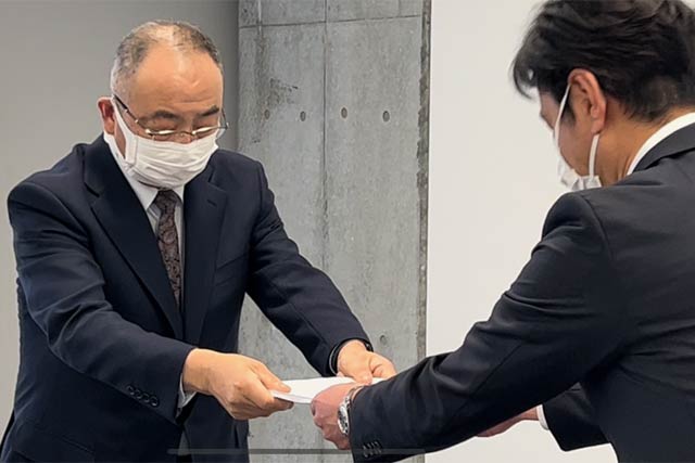 小林教育長(左)に調査報告書を手渡す吉澤委員長
