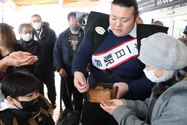 投げる福豆をファンに手渡してサービス