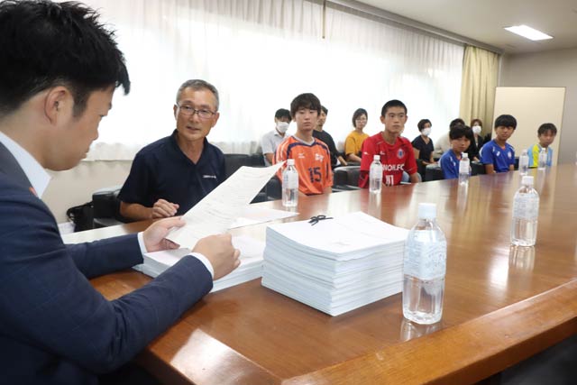 署名に目を落とす滝沢市長