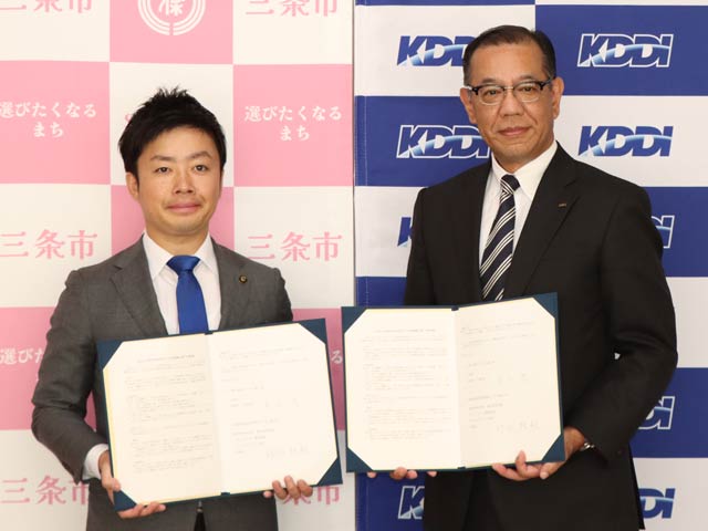 包括連携協定に署名した滝沢市長(左)とKDDIソリューション事業本部・ビジネスデザイン本部の那谷本部長