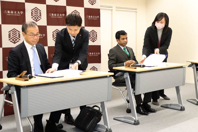 連携協定締結式で協定書に署名
