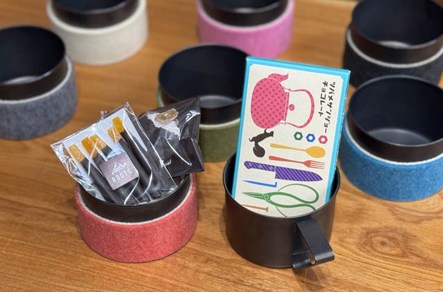 「燕三条スイーツカップ」手前の左がスリーブカップとオランジェットと干し柿チョコレートとのセット、右がマグカップとツバメサンジョーチョコレートのセット