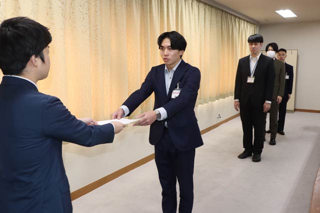リクルーターに任命した職員に滝沢市長から任命書を手渡す